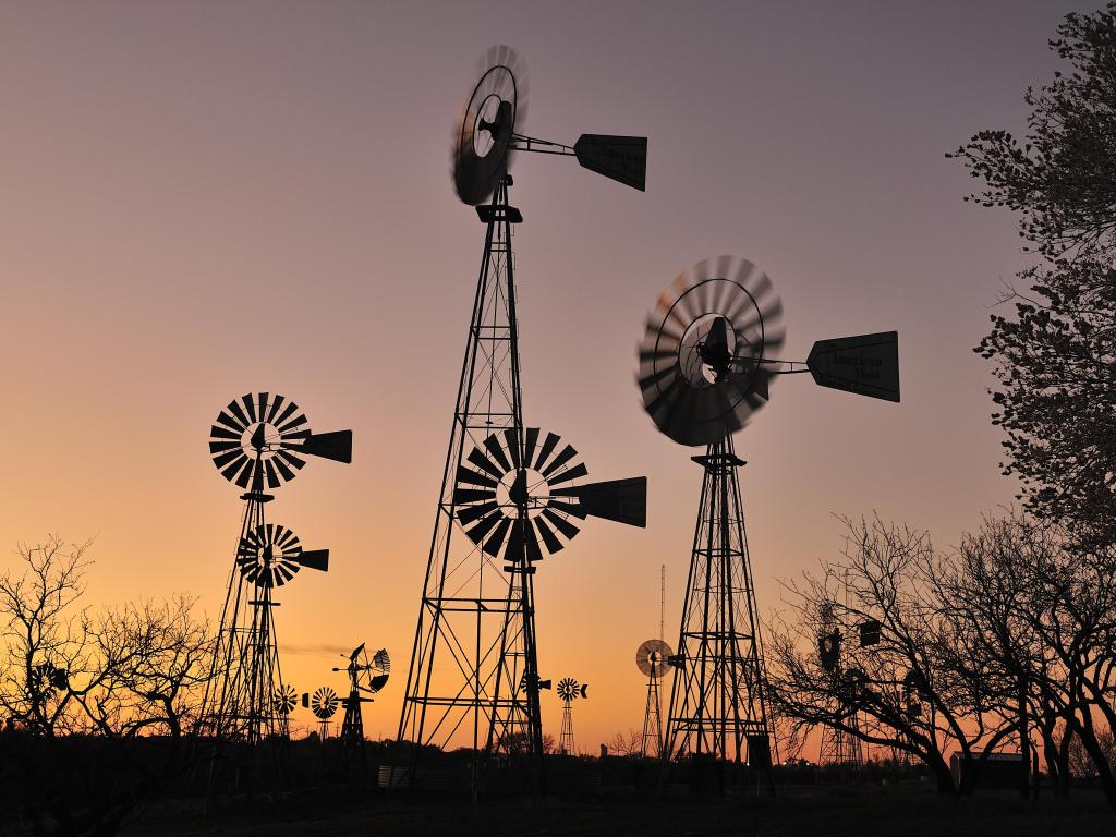 The American Wind Power Center in Lubbock, Texas, where various windmills are showcased, photo taken during sunset