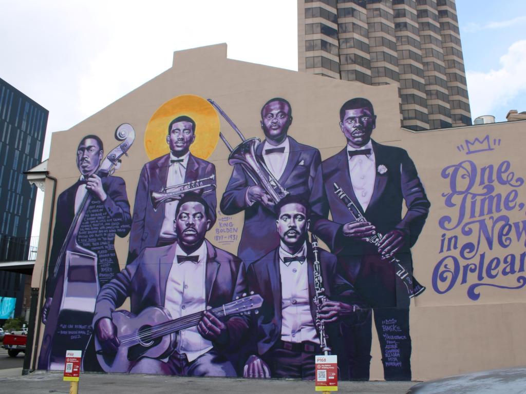 Mural of historical jazz players on the side of a building in downtown