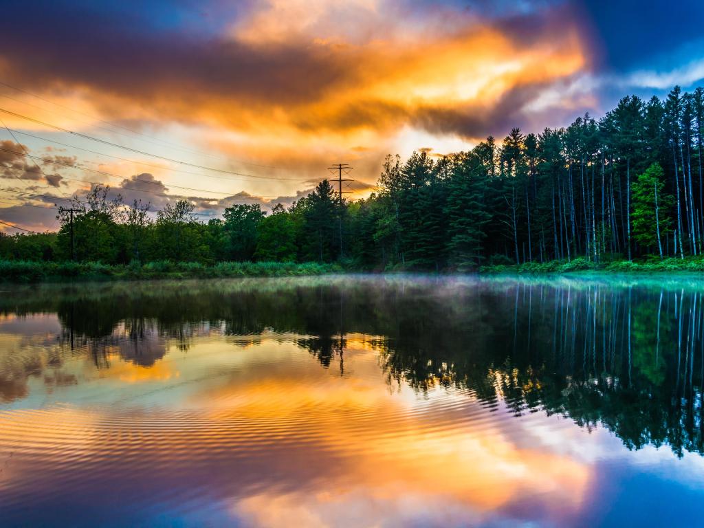 Delaware Water Gap National Recreational Area, New Jersey, USA taken at sunset with the sky reflecting in a pond and trees lining the distance. 