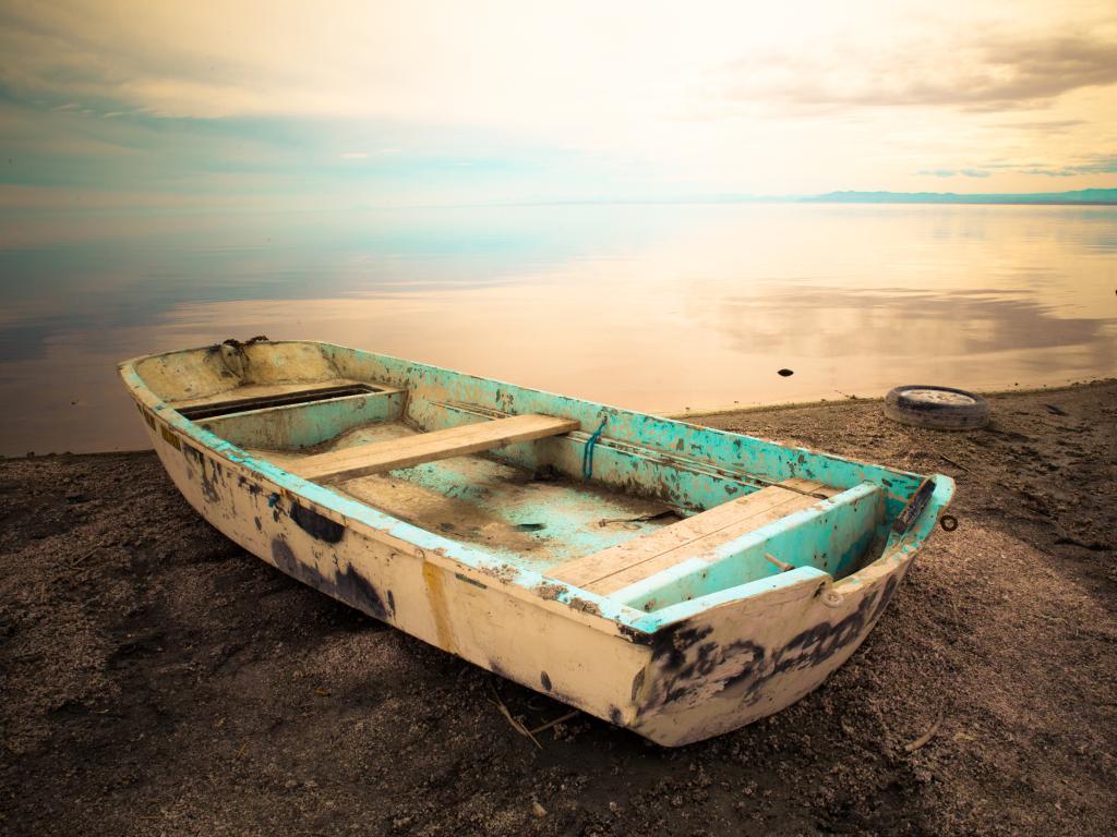 An old boat sitting on the edge of Salton Sea, California