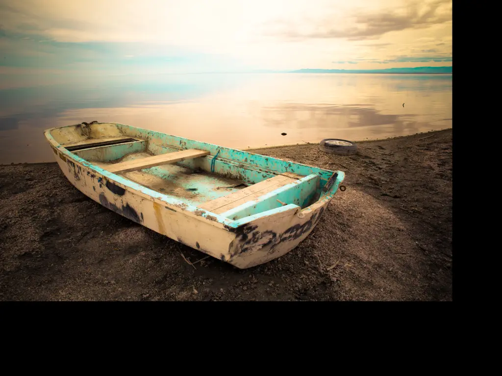 An old boat sitting on the edge of Salton Sea, California