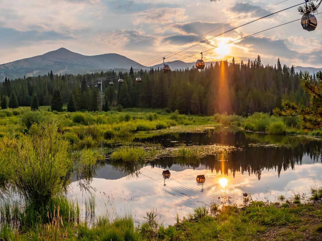 View of cable cars from the lush wetlands at Cucumber Gulch near Breckenridge, Colorado at sunset