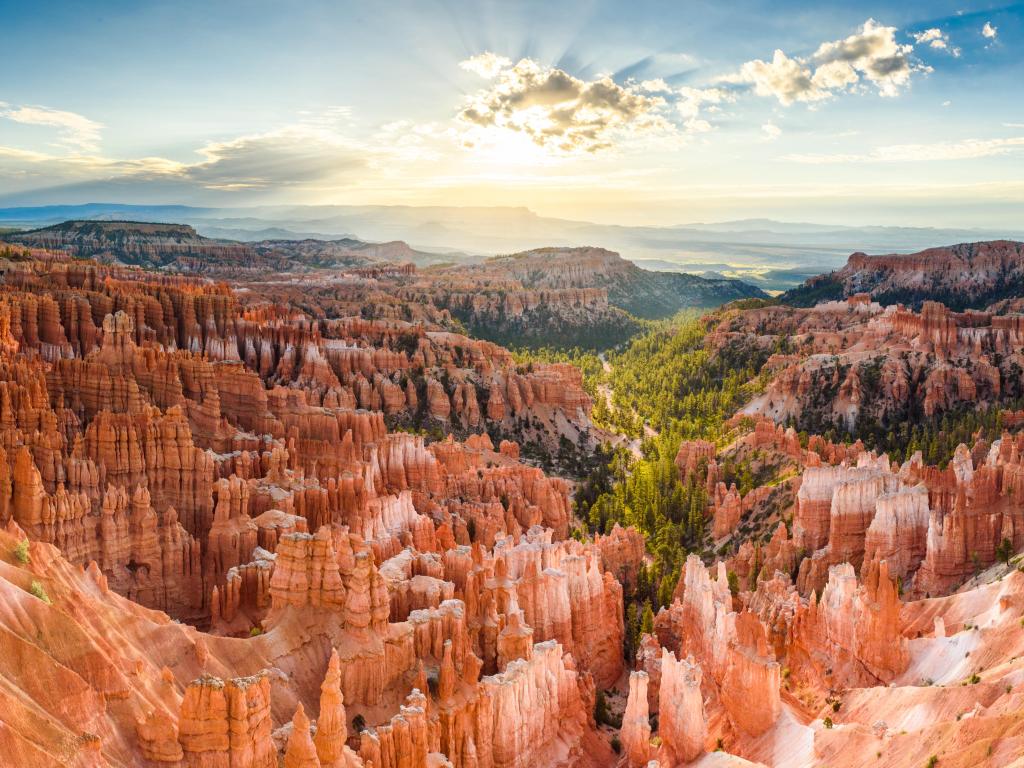 Bryce Canyon National Park, Utah, USA with a panoramic view of amazing hoodoos sandstone formations in scenic Bryce Canyon National Park in beautiful golden morning light at sunrise with dramatic sky and blue sky, Utah, USA