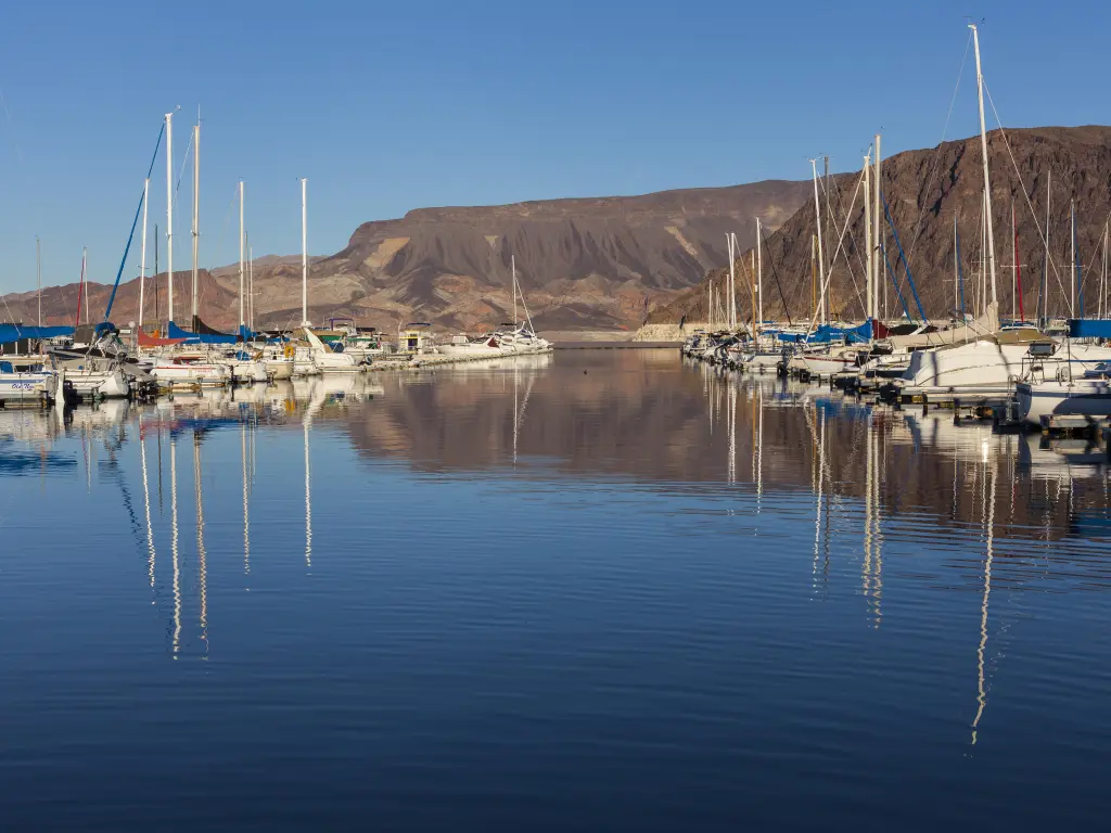 Boats docked at the marina on Lake Mead with hills in the background
