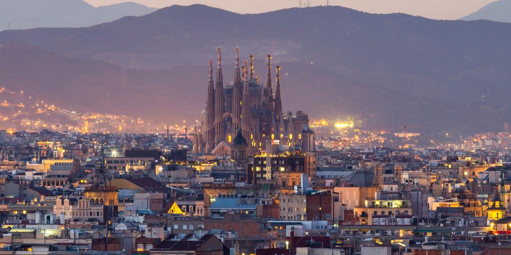 Sagrada Familia against the skyline of Barcelona, Spain, at dusk