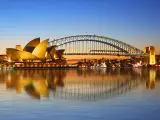 The view of Sydney Opera House and bridge viewed from Circular Quay as the sun sets