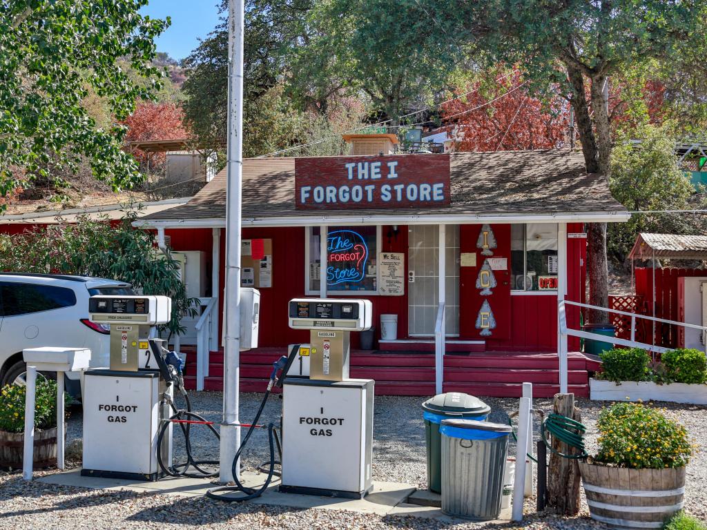 The quirky and charming red wooden building of The I Forgot Store, with its gas pumps outside, near Pine Flat Lake in California