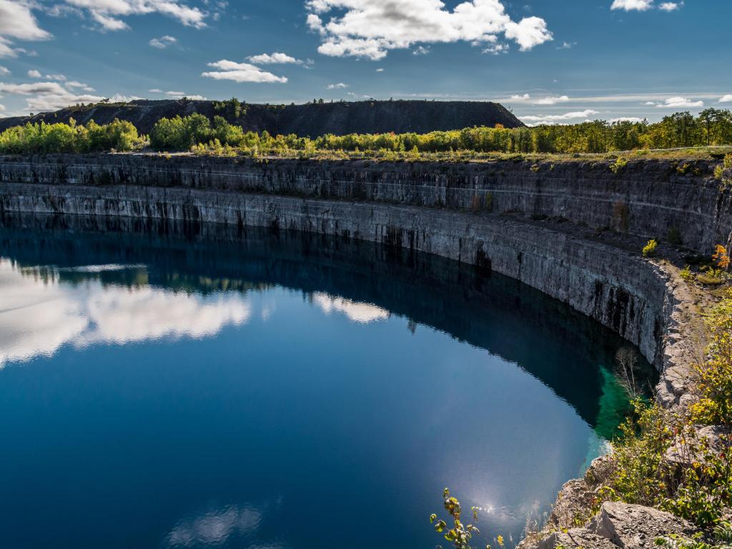 Blue hole lake mine with bright blue water in round-sided mine lake