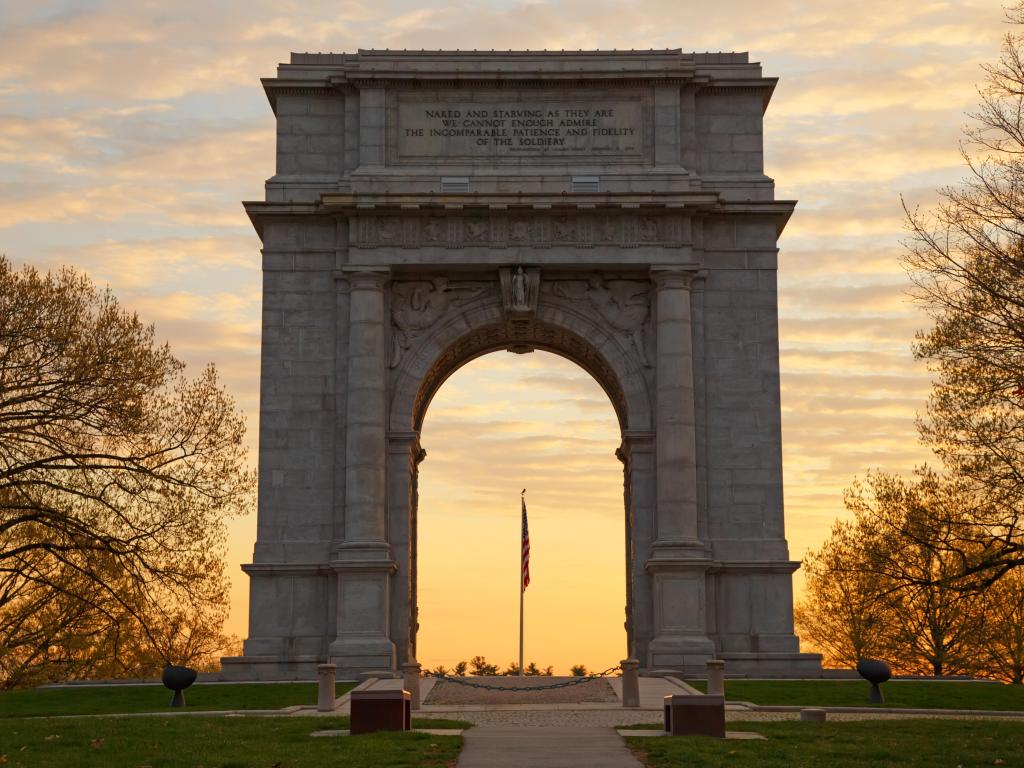 Valley Forge National Historical Park in Pennsylvania, USA with a central view of The National Memorial Arch monument dedicated to George Washington and the United States Continental Army at sunset.