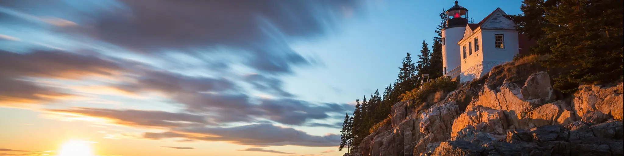 Acadia National Park, Maine, USA with a view of the Bass Harbor Lighthouse at sunset.