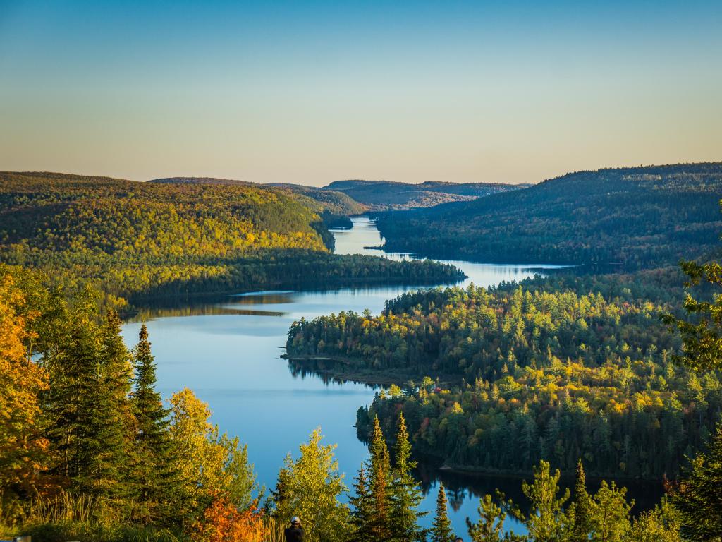 Mauricie National Park, Quebec, Canada with a view of the lake at sunset on an Autumn day with trees lining the waters edge. 