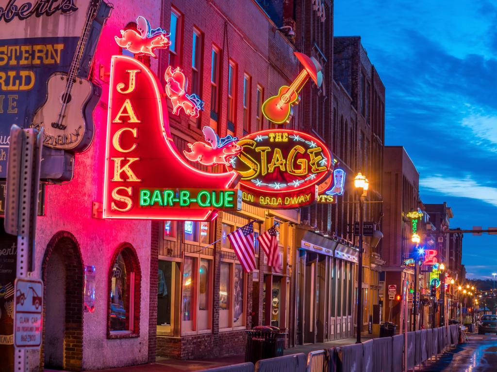 Nashville, Tennessee, USA with a view of neon signs on Lower Broadway Area at night.