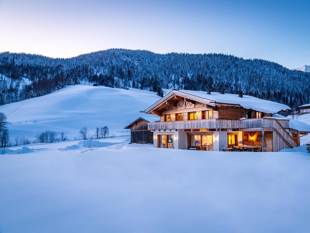 Wooden chalet in the alps on a cold winter evening