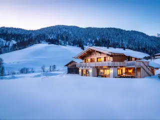 Wooden chalet in the alps on a cold winter evening
