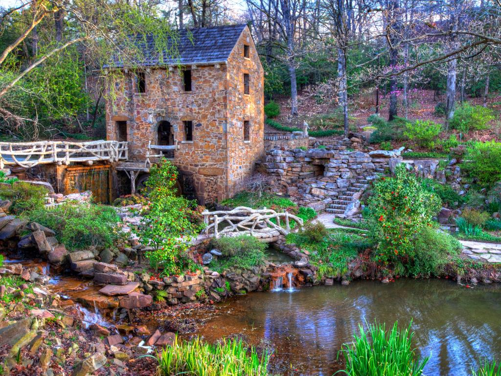 Little Rock, Arkansas, USA with a view of The Old Mill surrounded by bridges, paths and a river.