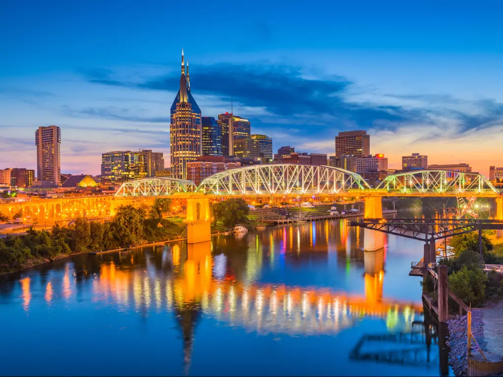 Nashville, Tennessee, USA downtown city skyline on the Cumberland River at dusk.