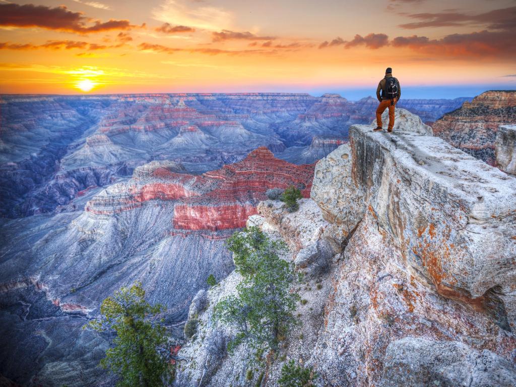 Grand Canyon at sunrise. with a tourist viewing the beautiful landscape