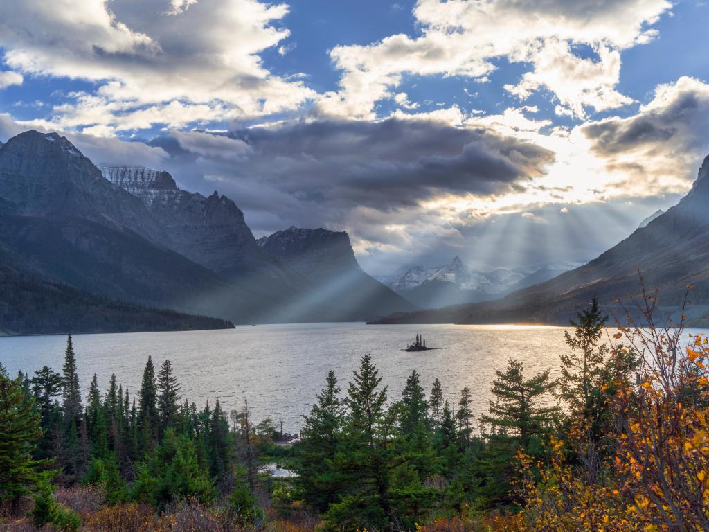 St. Mary Lake and Wild Goose Island, Glacier National Park, Montana as the sun sets over a cloudy sky