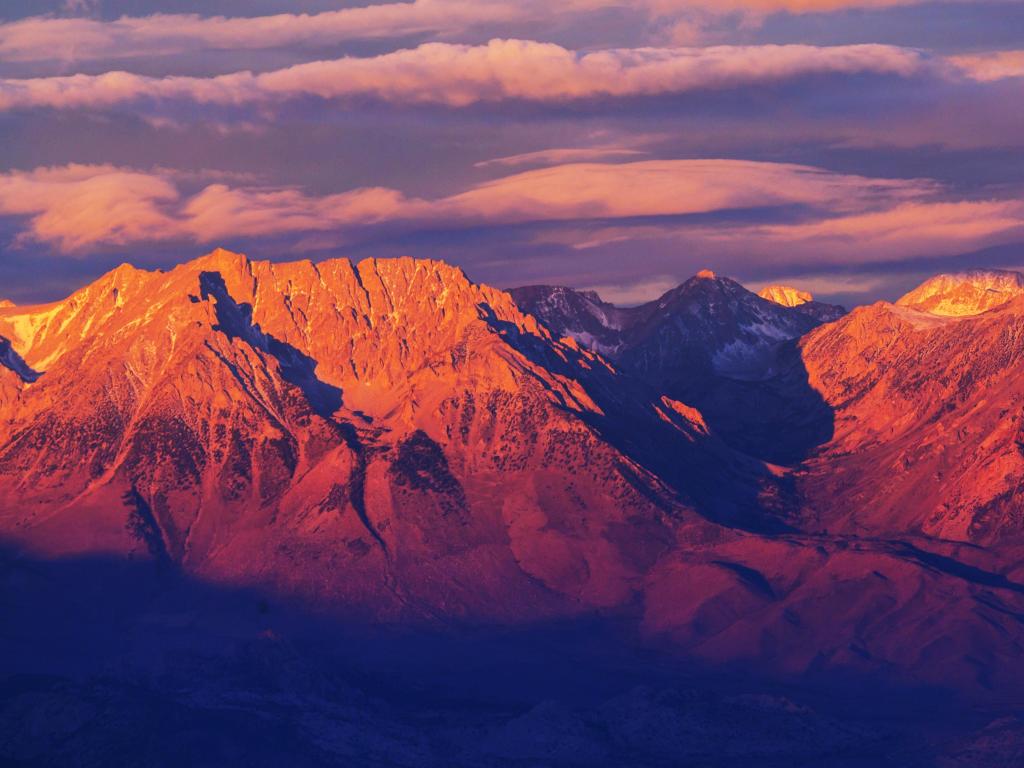 Sierra Nevada mountains, USA taken at sunset with the red mountains in the background and a dramatic sky above. 