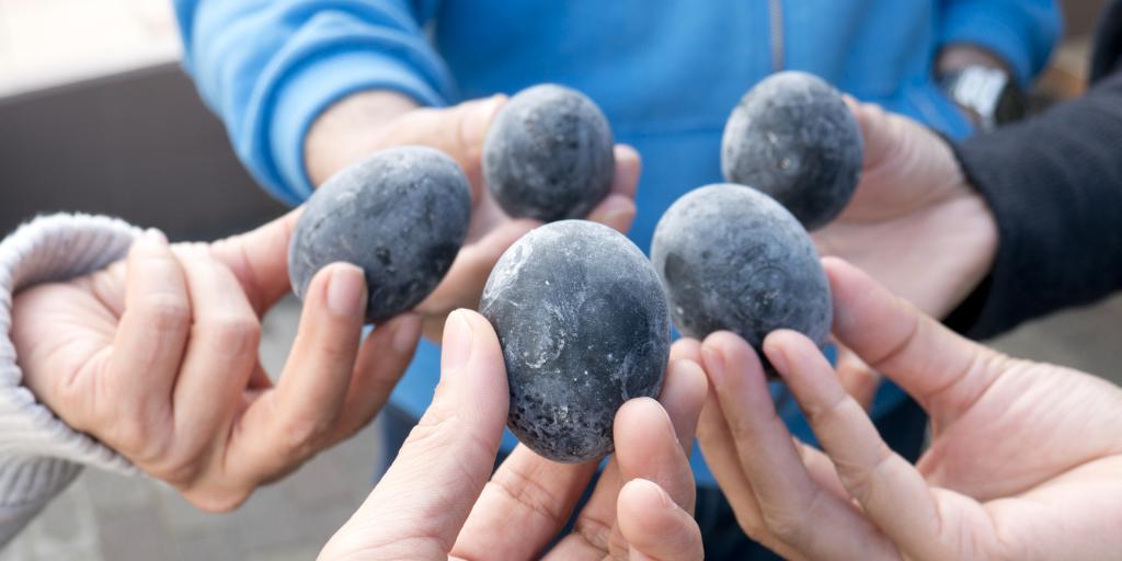 People holding black eggs in Hakone, Japan 