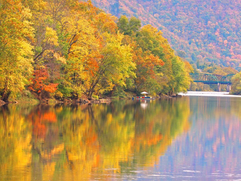 Kanawha River, West Virginia, USA with autumn reflections in the river and golden trees surrounding the banks.
