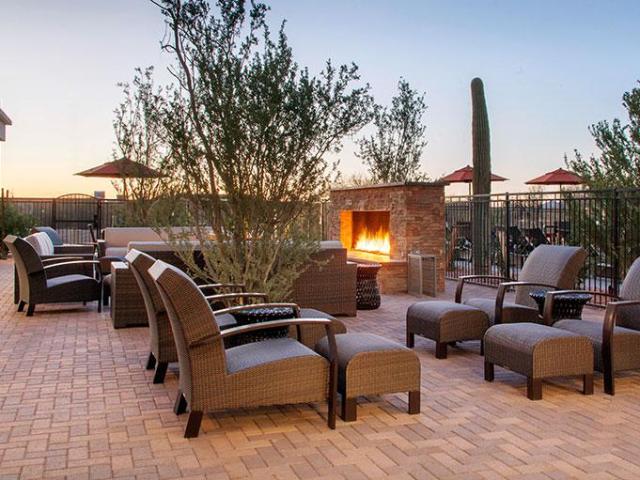 Outdoor terrace with loungers and open fireplace at Cambria Hotel Phoenix