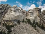 Mount Rushmore National Monument in South Dakota with a blue sky and clouds.