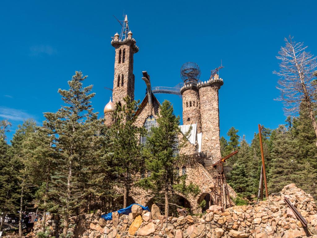 The roadside attraction in Colorado on a sunny day, surrounded by trees