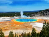 Famous trail of Grand Prismatic Springs in Yellowstone National Park from high angle view. Beautiful hot springs with vivid color blue green orange in Wyoming.