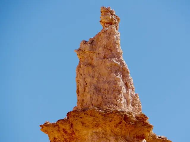 A rock formation resembling Queen Victoria, a sunny day in Bryce Canyon National Park