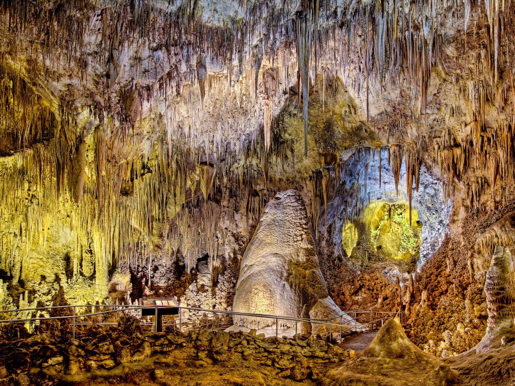 Carlsbad Caverns National Park, New Mexico, USA with an underground view of the Crystal Spring Dome lit up by lamps and a pathway.