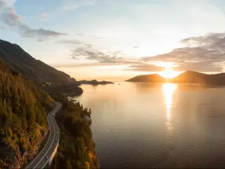 The Sea to Sky Highway, West Vancouver, British Columbia, Canada with a view of Horseshoe Bay take as an aerial panoramic view during a colorful sunset in Fall season.