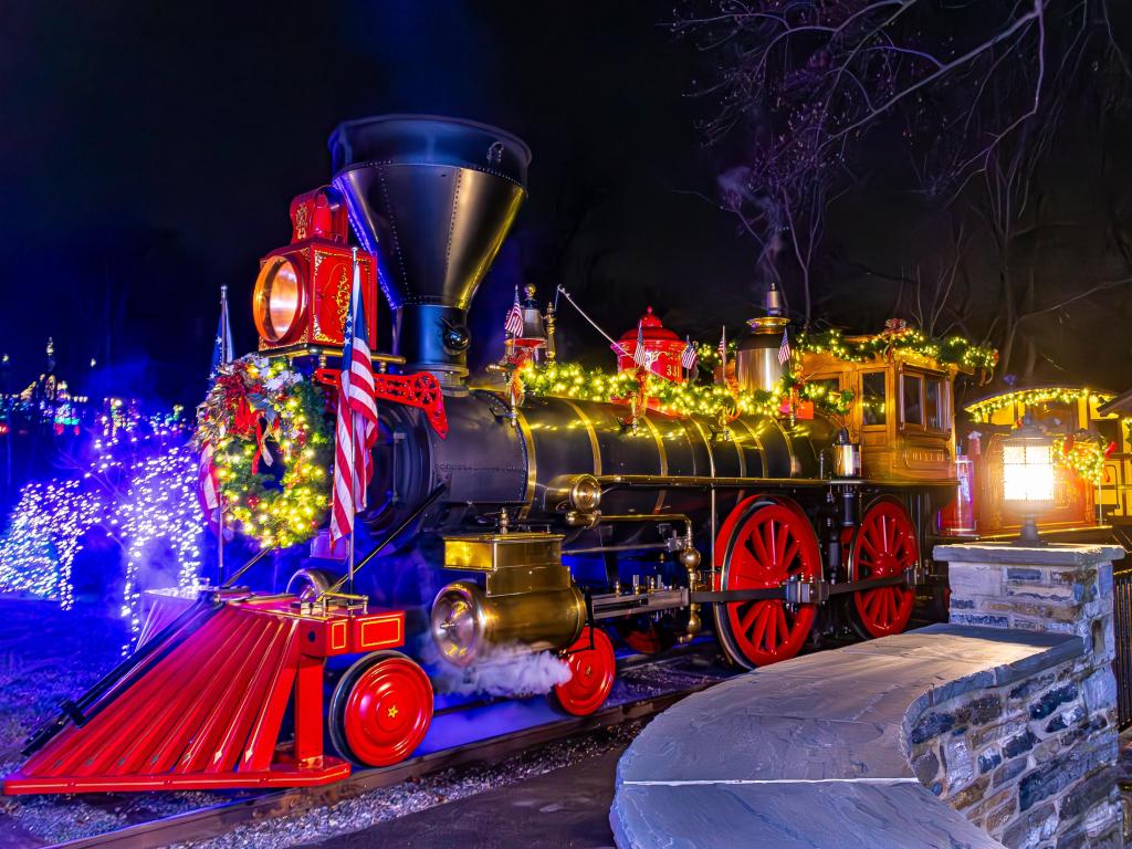 An antique 1860s steam engine, with Christmas decorations on a clear winter day