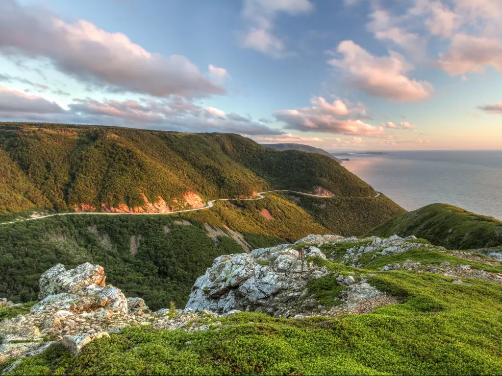 Cape Breton Highlands National Park, Nova Scotia with the winding Cabot Trail road seen from high above on the Skyline Trail at sunset.