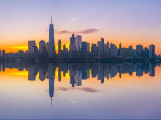 NYC skyline reflected in the water in pastel colors