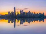 NYC skyline reflected in the water in pastel colors