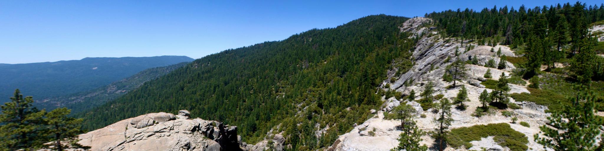 Winding rockface and dense forests along Chilnualna Falls Hike in Yosemite National Park 