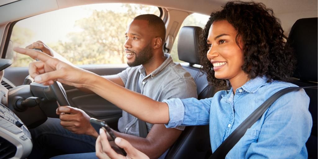 Couple laughs while playing a game on a road trip