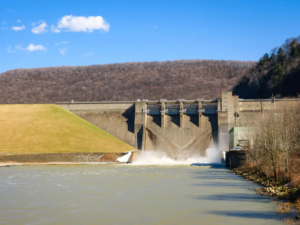 View of gushing waters of Kinzua Dam, with woodlands surrounding the dams structure, New York