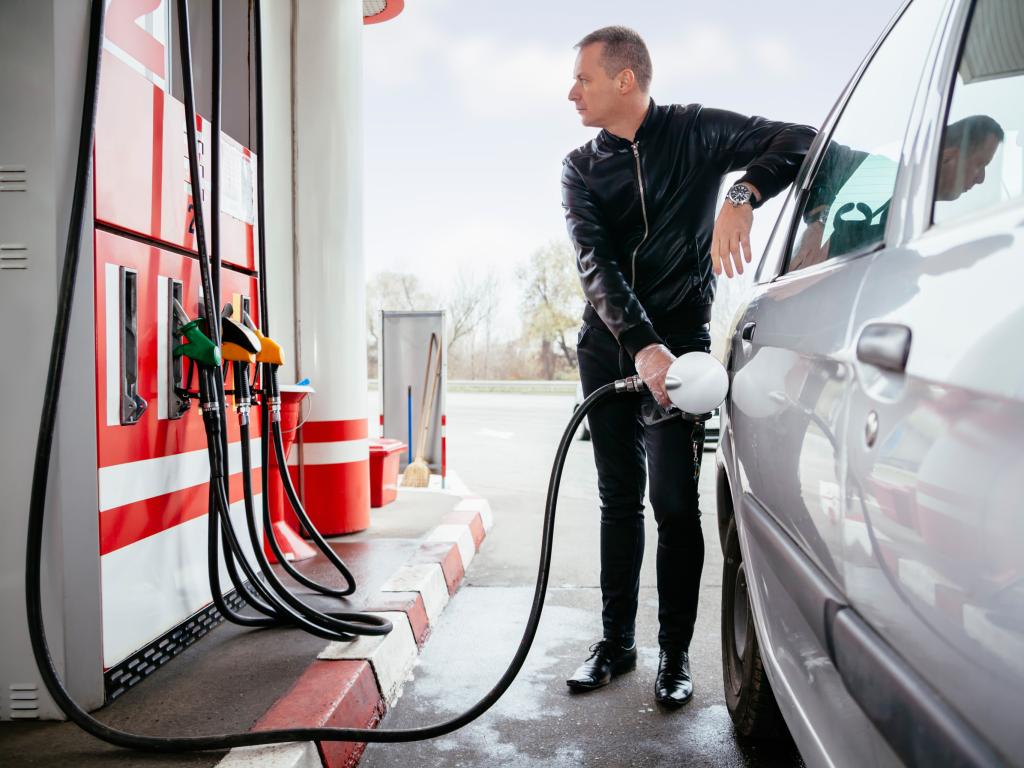 Man filling up his car with gas at the petrol station