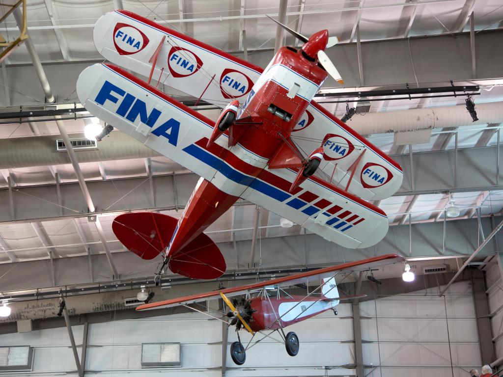 A red propeller plane hanging from the ceiling of the museum, located in Dallas