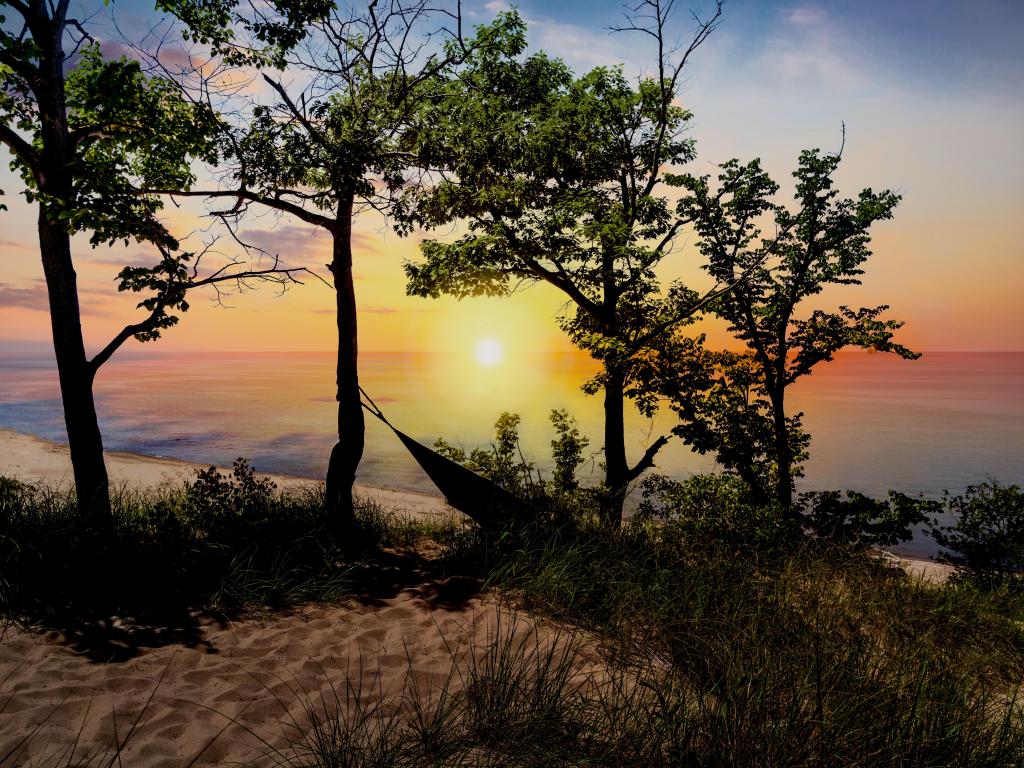 The silhouette of Indiana Dunes State Park landscape overlooking Lake Michigan at sunset