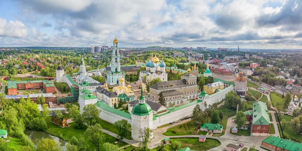 Aerial view of the gold and blue domes of Trinity Lavra of St. Sergius with Sergiev Posad in the background