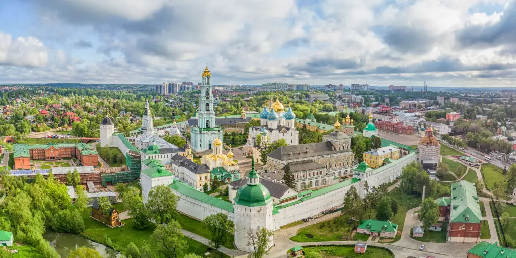 Aerial view of the gold and blue domes of Trinity Lavra of St. Sergius with Sergiev Posad in the background