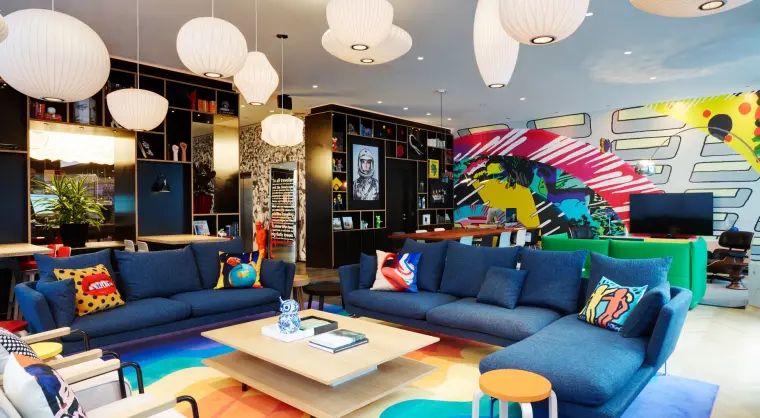 Bright lounge with bold furniture and artwork in the commual space at citizenM Washington DC Capitol