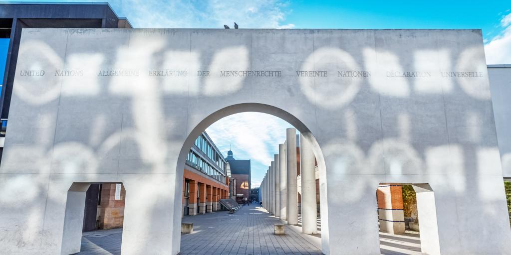 The white archway at the start of the Nuremberg Way of Rights, Germany, with the columns behind it