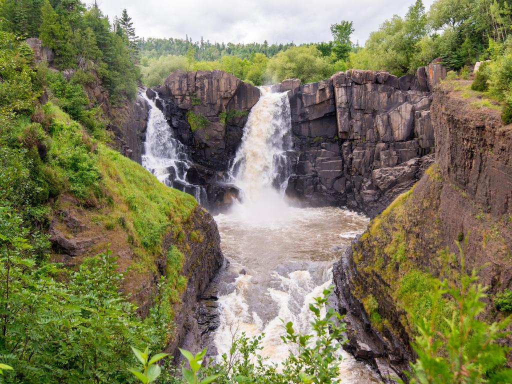 Grand Portage State Park, Minnesota, USA taken at the High Falls waterfall with trees surrounding it.