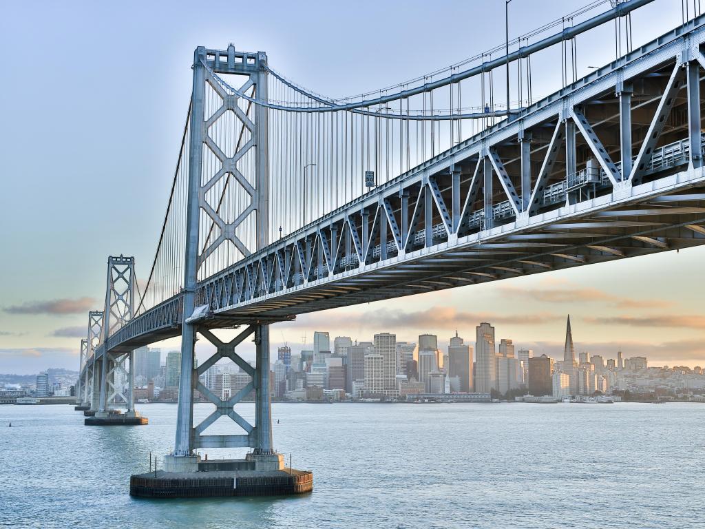 San Francisco, California, USA with a sunset over San Francisco-Oakland Bay Bridge and San Francisco Skyline taken at Yerba Buena Island.