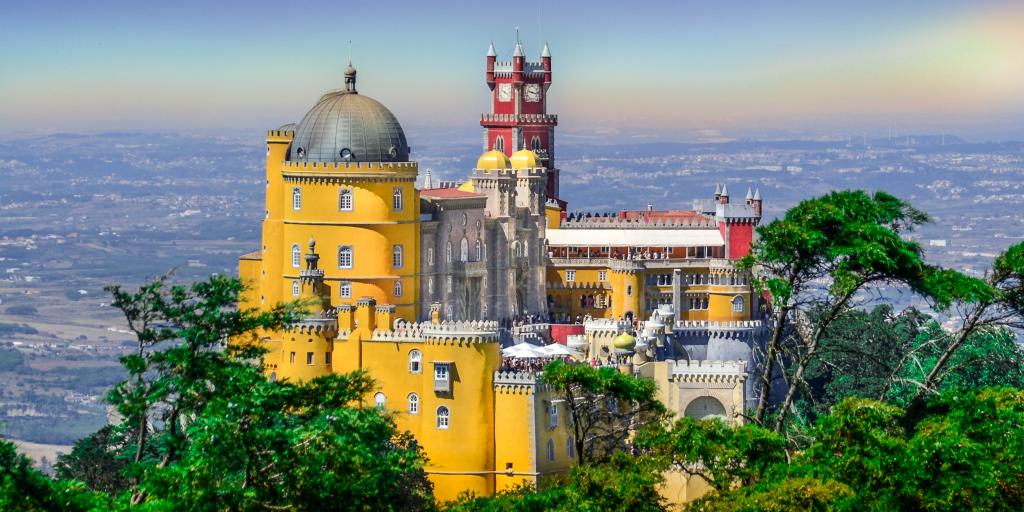 The bright colours and dramatic fairy tale-esque architecture of Pena Palace in Sintra