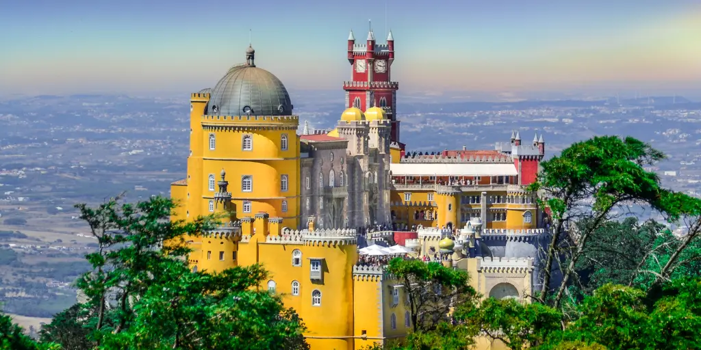 The bright colours and dramatic fairy tale-esque architecture of Pena Palace in Sintra